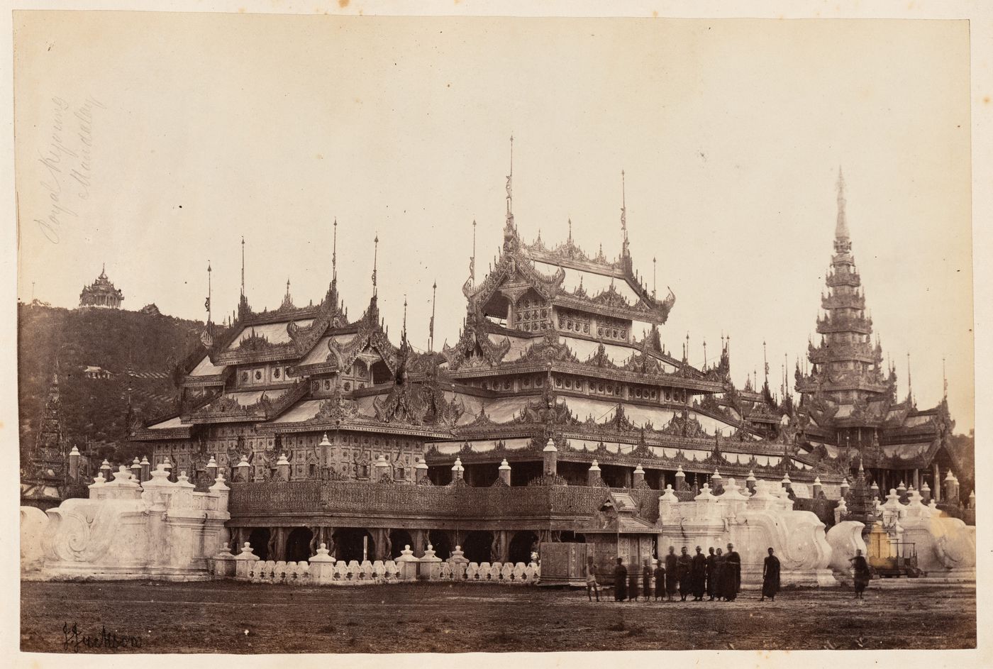 View of a monastery with monks in the foreground and Mandalay Hill in the background, Mandalay, Burma (now Myanmar)