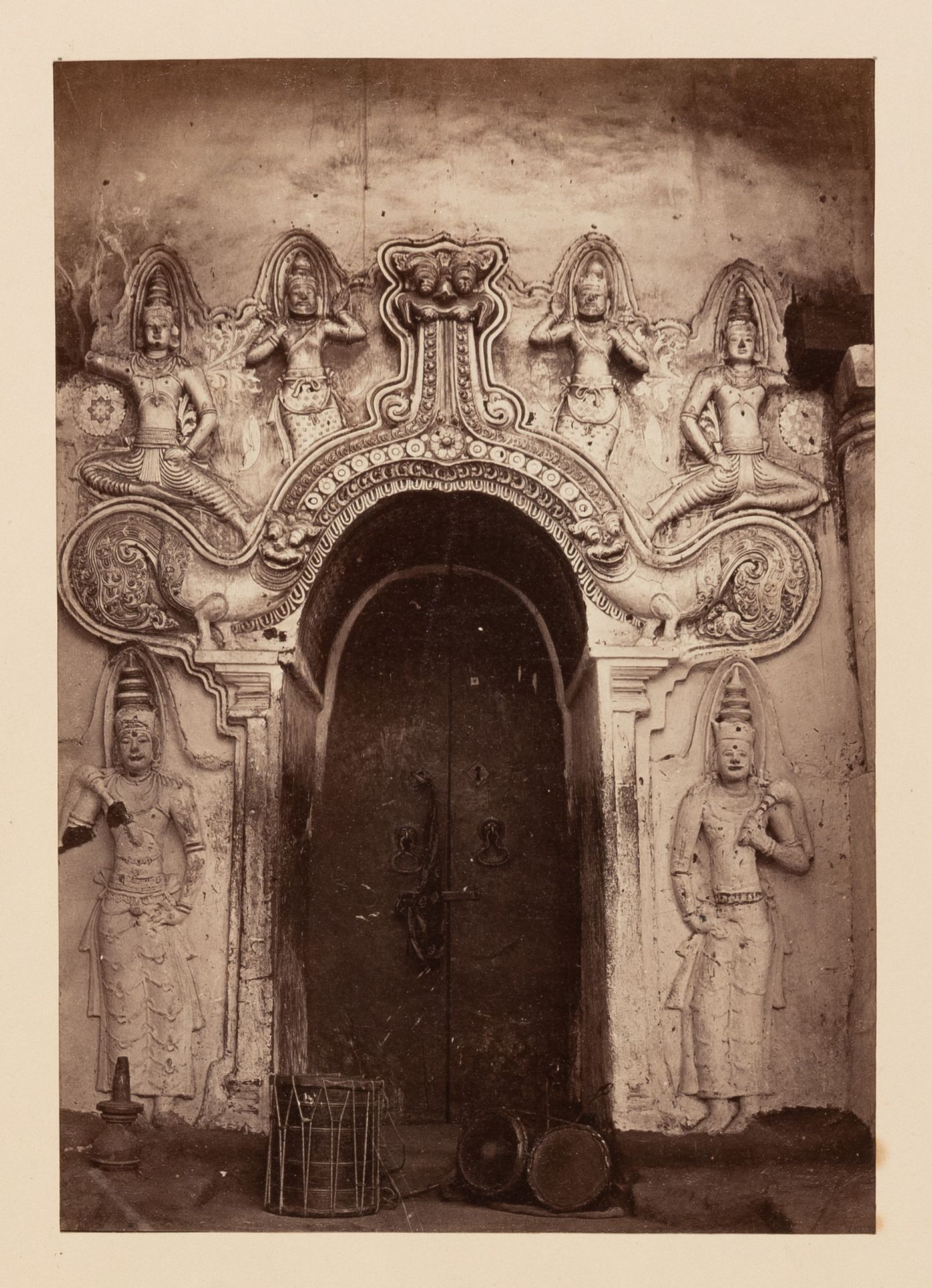 View of a temple door surrounded by reliefs, Ceylon (now Sri Lanka)