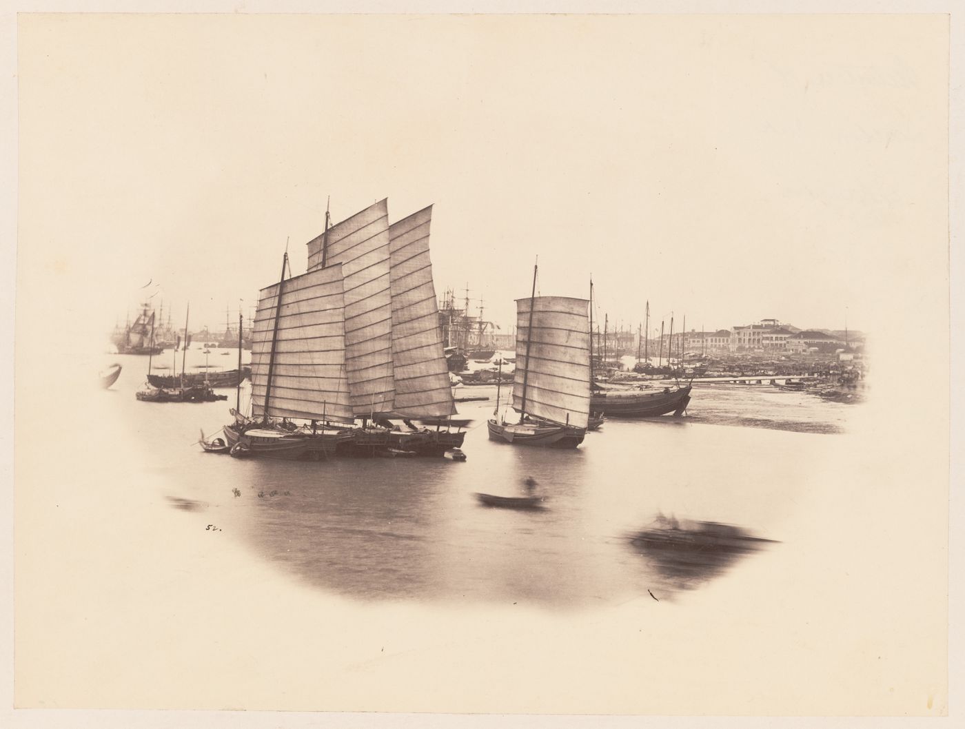 Vignette of junks and other sailing ships on the Wusong Jiang (also known as Suzhou River) showing buildings in the background, Shanghai, China