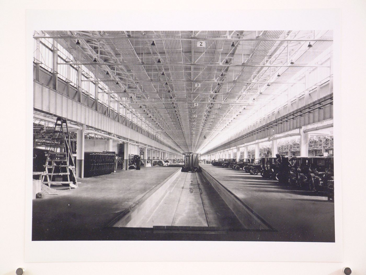 Interior view of the Assembly [?] Building showing cars and a train at the loading dock, Ford Motor Company Automobile Assembly Plant, Richmond, California