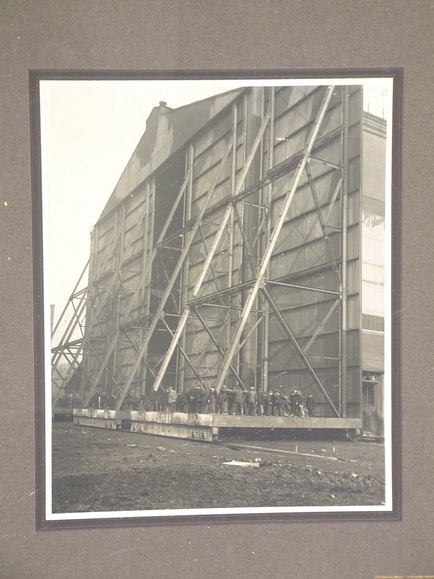 Exterior view of a group of people outside an airship hangar, United Kingdom