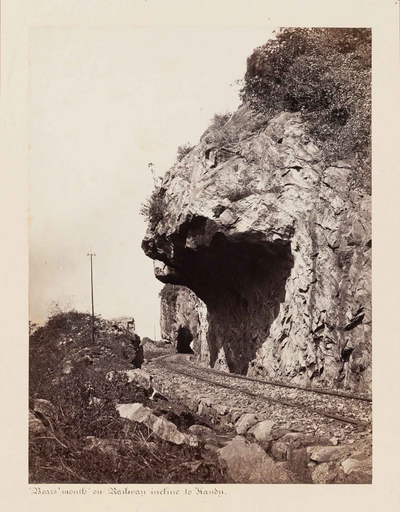 View of the "Bears' Mouth" on the Colombo-Kandy Railway with a tunnel in the background, possibly Tunnel No. 9, Ceylon (now Sri Lanka)