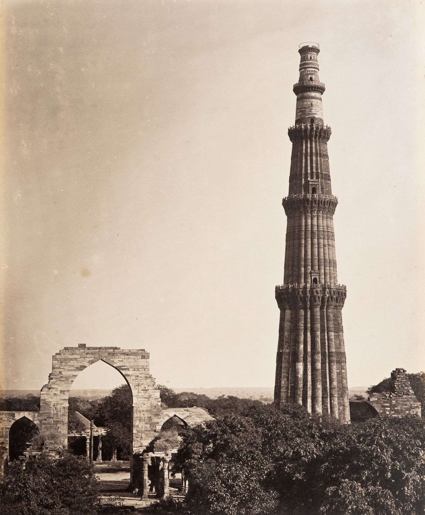 View of Qutb Minar and the arched screen façade of Quwwat al-Islam [Might of Islam] Mosque, Quwwat al-Islam Mosque Complex, Delhi, India