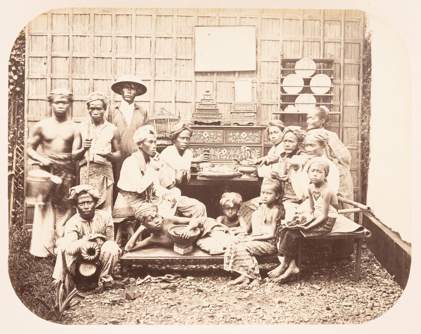 Group portrait of people with a chest of drawers and other furniture, probably in Batavia (now Jakarta), Dutch East Indies (now Indonesia)