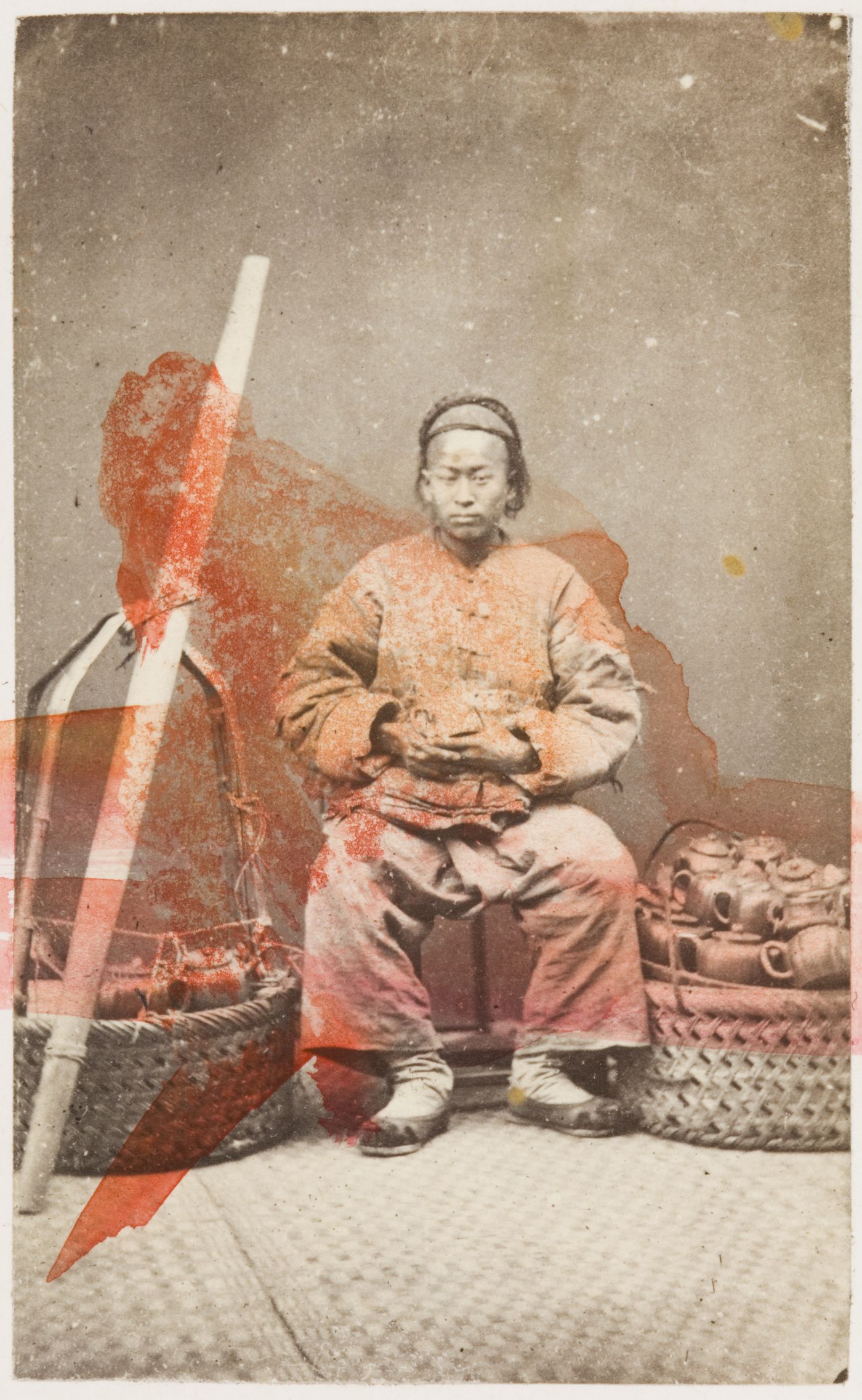 Portrait of a Chinese peddler seated with his carrying pole and two ...