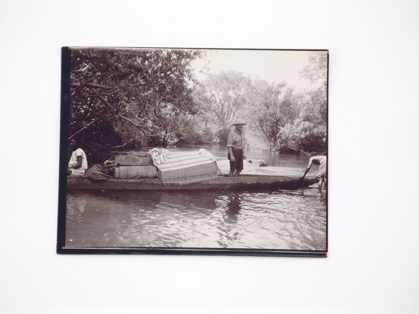 View of European man in a mokoro (wooden dugout canoe) boat, Zambezi River