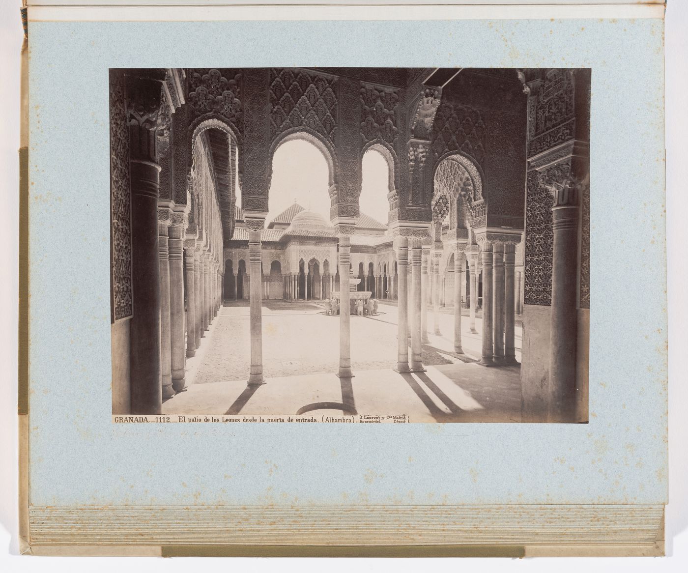 View of arches, pillars, and central fountain in Court of the Lions, from west pavilion, Alhambra, Granada, Spain

