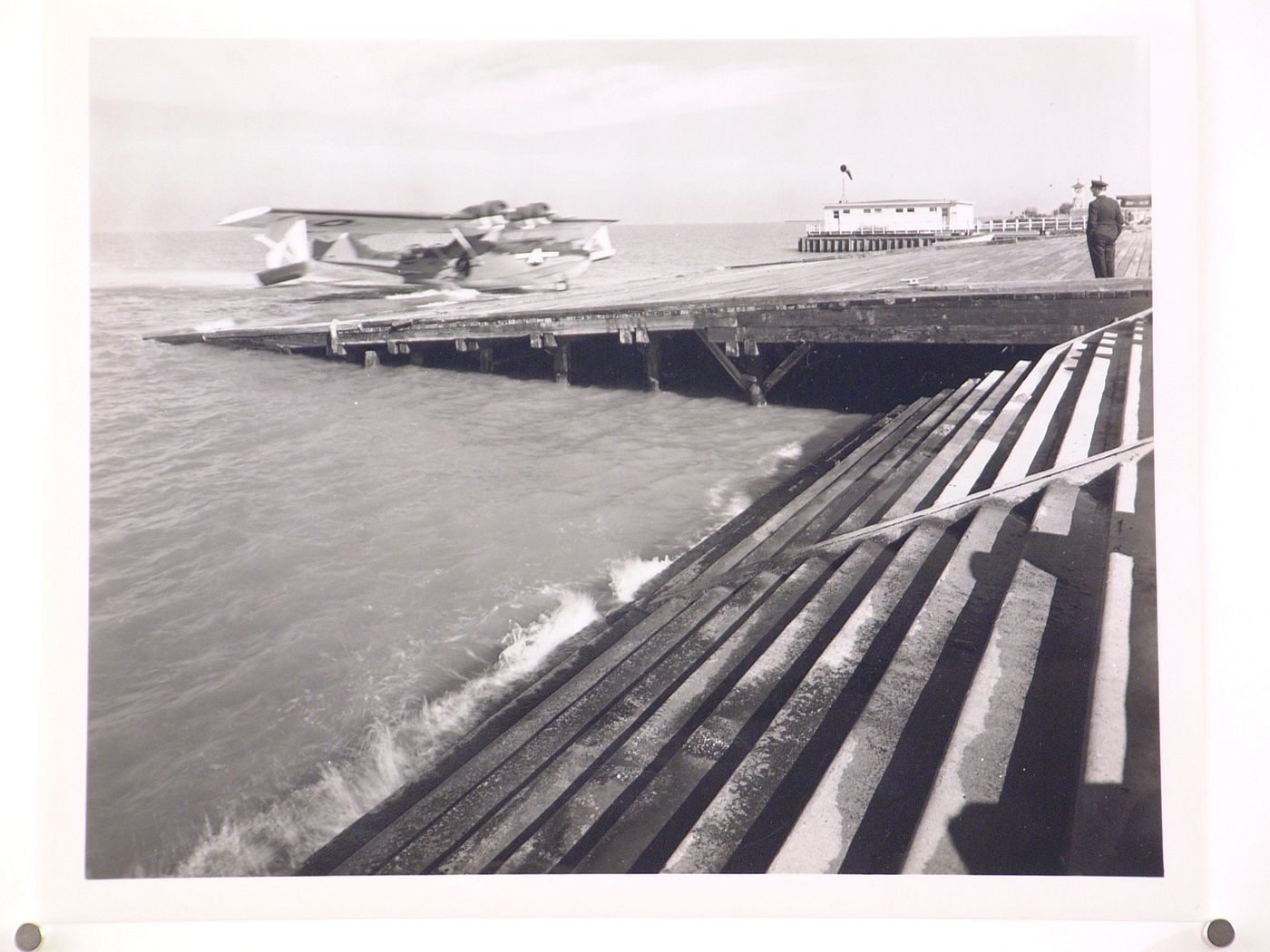 View of the Seaplane Ramp and Boathouse showing a plane landing, Consolidated Aircraft Corporation Assembly Plant, New Orleans, Louisiana