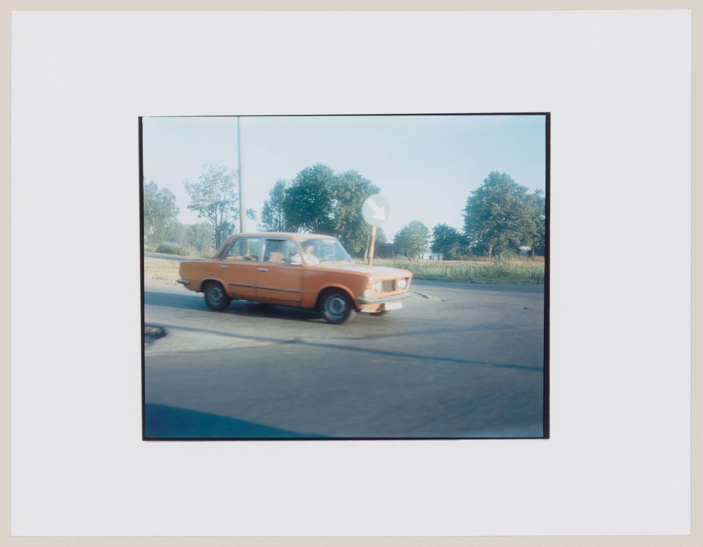 View of an automobile at an intersection showing trees and agricultural land in the background, Przyleg, near Strzelce Kraje'nskie, Poland (from the series "In between cities")