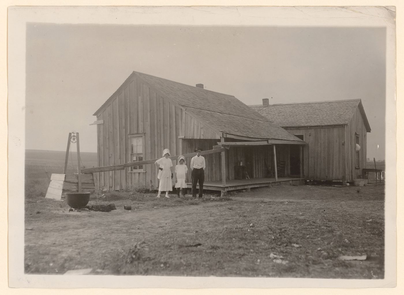 View of members of the Tripp family in front of the farmhouse they rent near West, Texas, United States