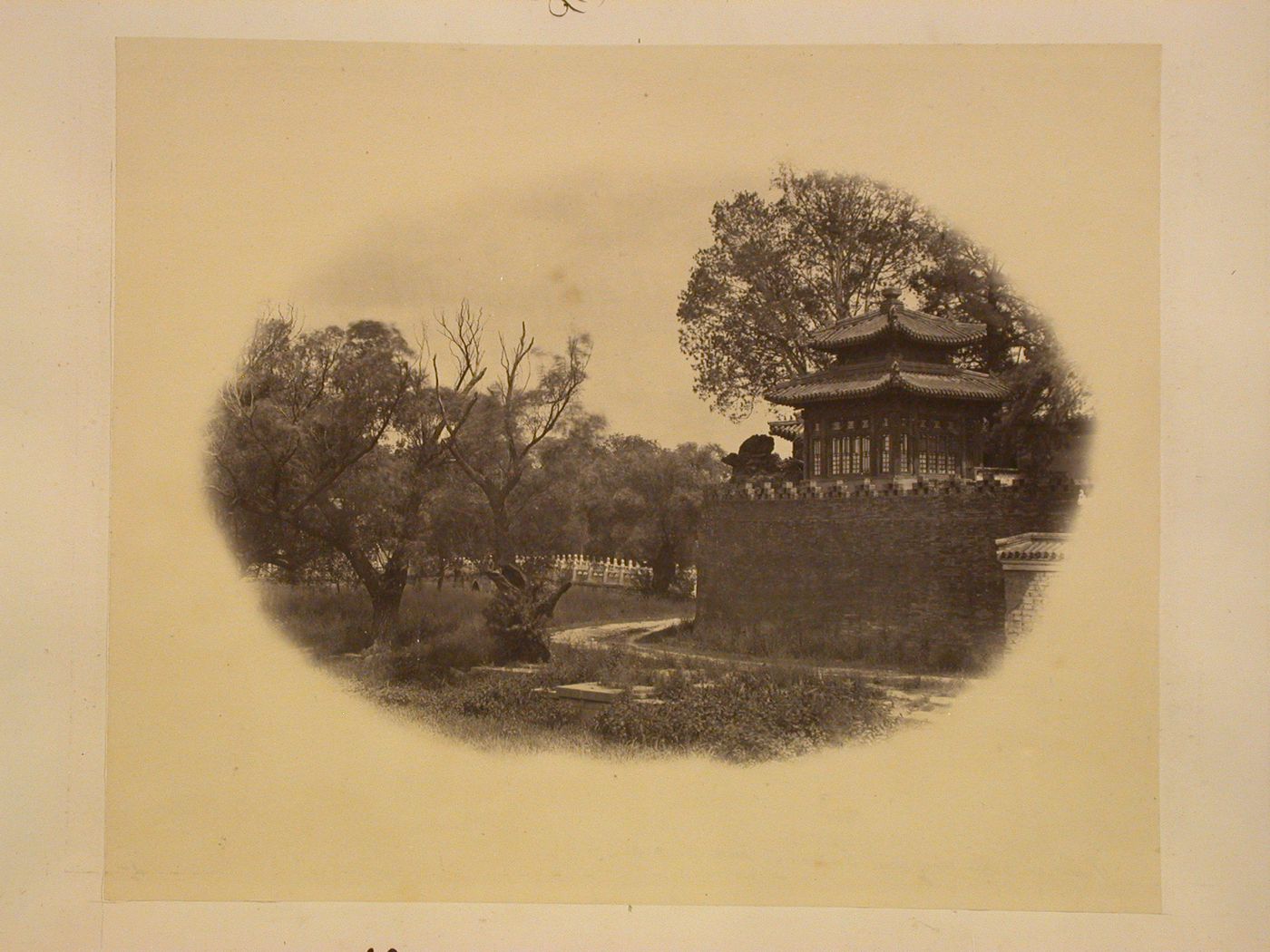 View of the wall of the Round City [Tuancheng] and a building with the Bridge of Everlasting Peace [Yong'an Bridge] in the background, Beihai (now Beihai Park), Peking (now Beijing), China