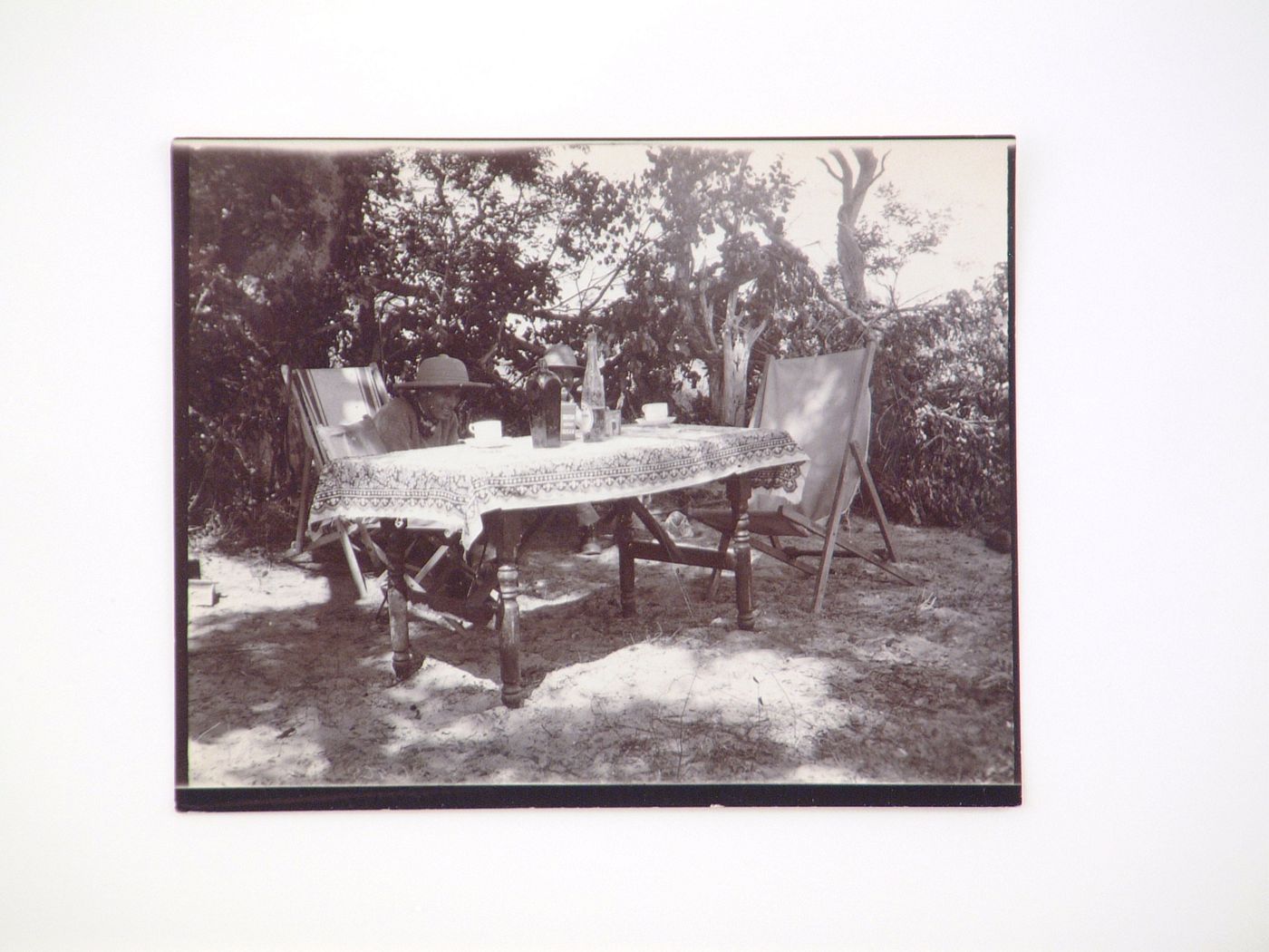 View of two men sitting outdoors at a table with tea, near Zambezi River