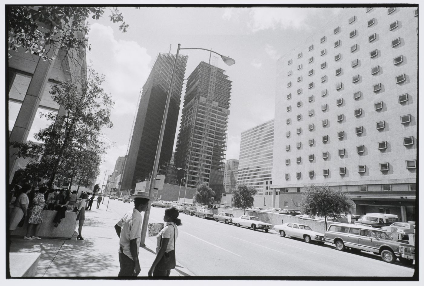 Street scene, pedestrians with parked cars