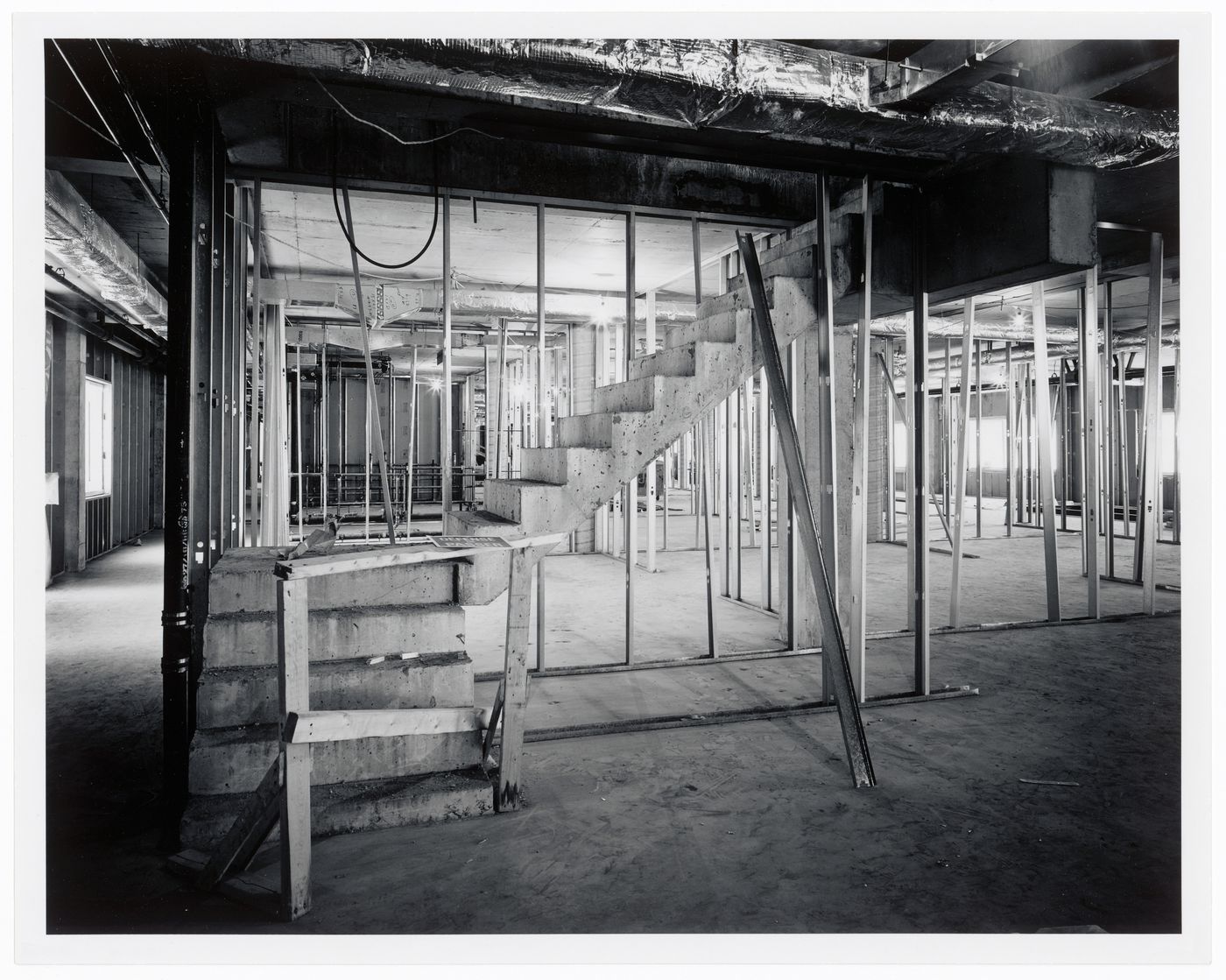 Interior view of the curatorial level [?] showing concrete stairs and metal wall studs, Canadian Centre for Architecture under construction, Montréal, Québec