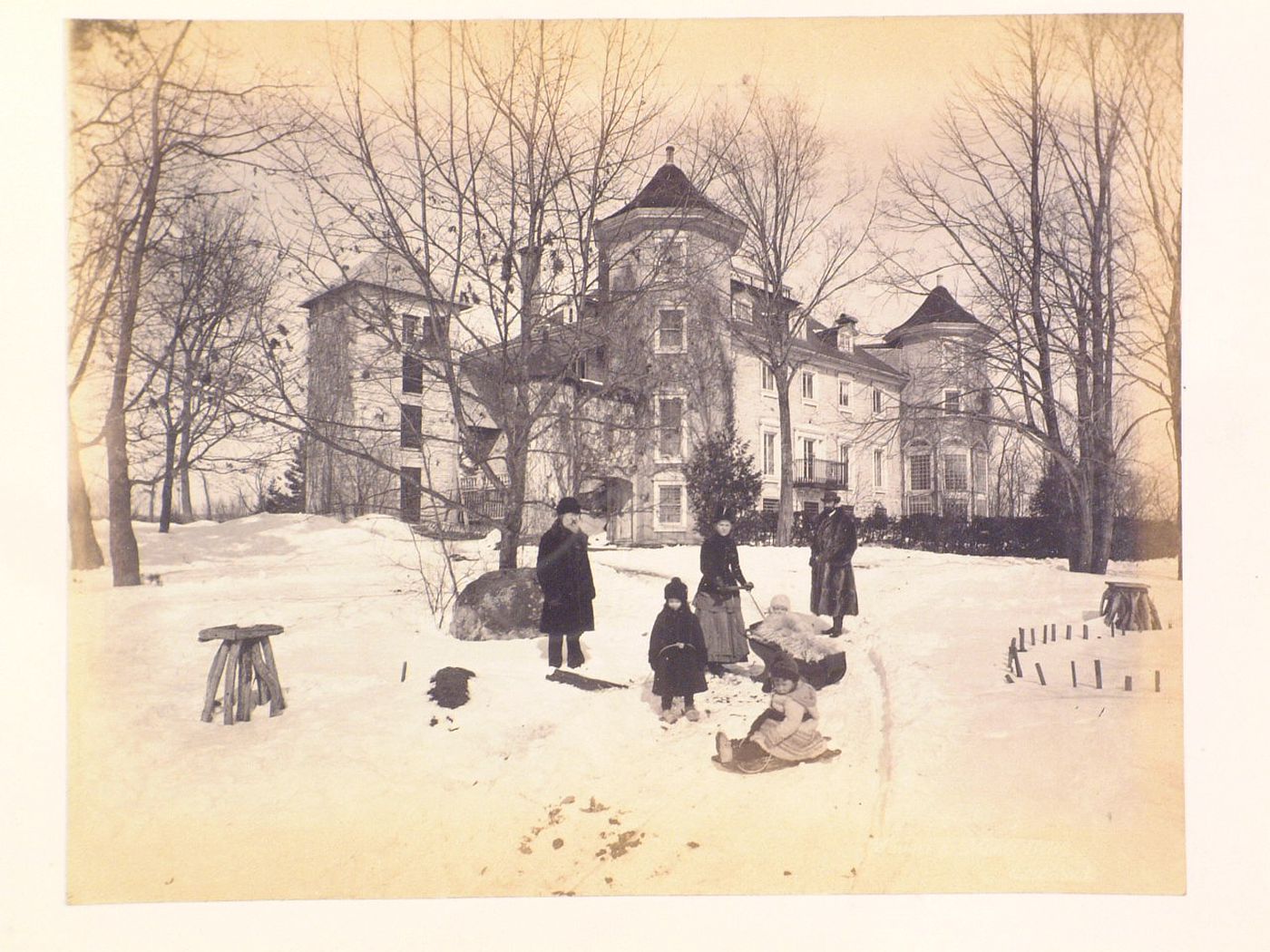 View of the rear façade of Manoir Louis-Joseph-Papineau in winter showing Amédée Papineau with his son Louis-Joseph and his  family, Allée du Seigneur, Montebello, Québec