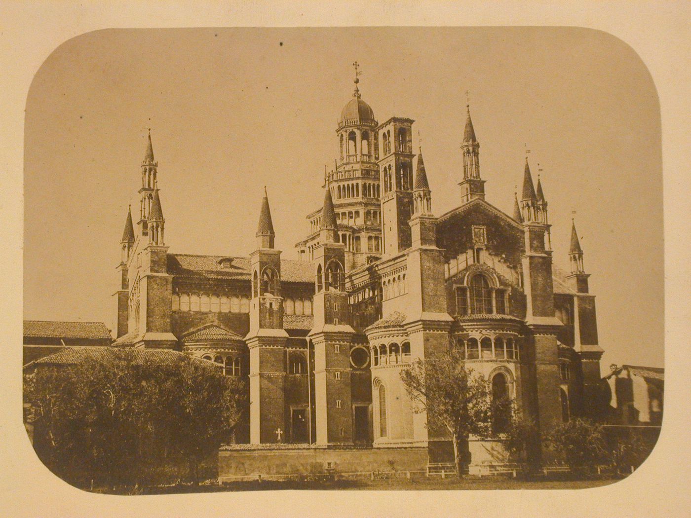 Partial view of the Certosa di Pavia showing the choir, a transept, the dome and towers, Pavia, Italy