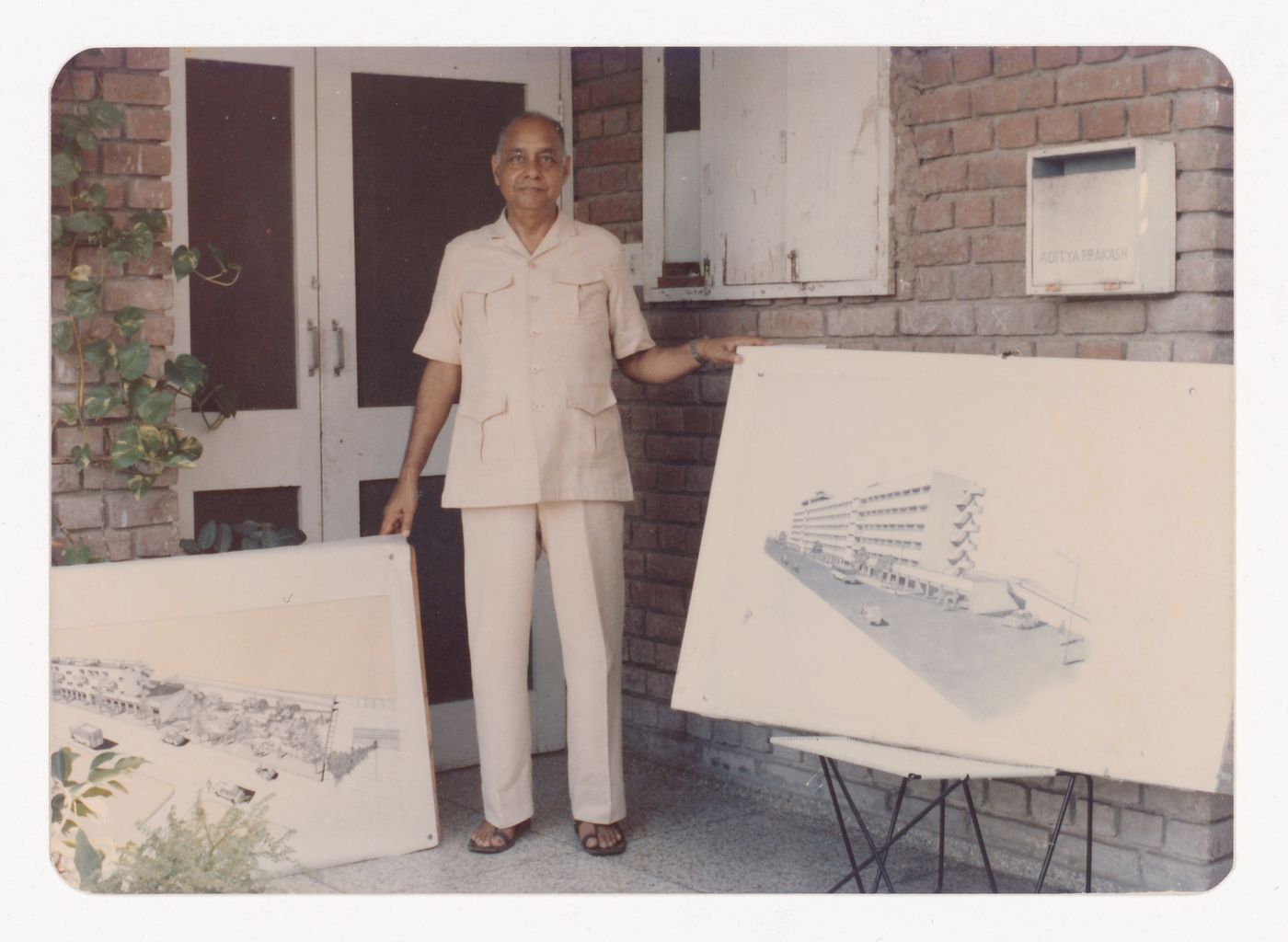 Photograph of Aditya Prakash showing two drawings