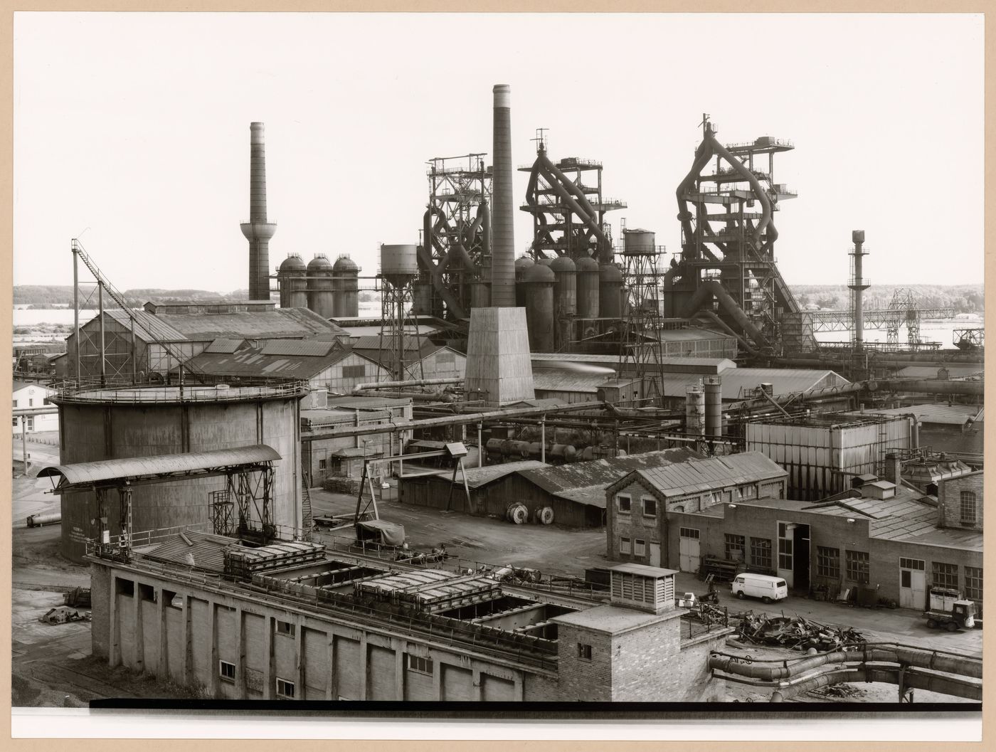 View of Metallhüttenwerk industrial plant showing blast furnace heads A, B, and C, Lübeck-Herrenwyk, Germany