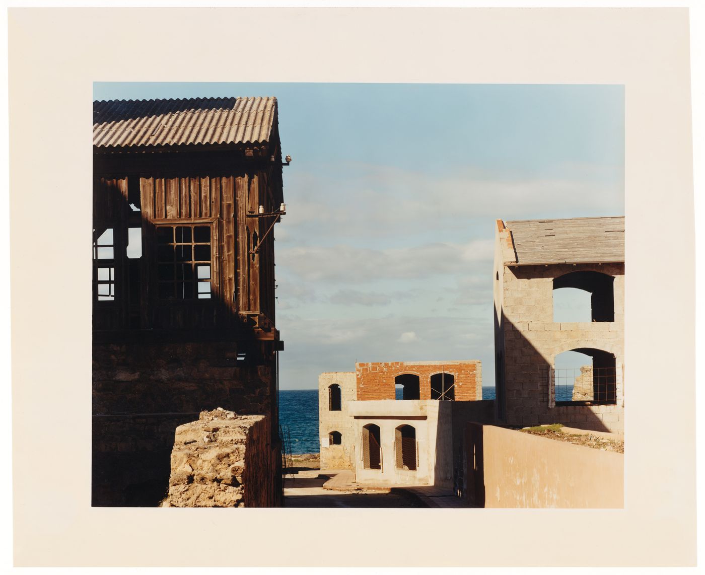 View of three buildings along the sea shore in Sassari, Sardinia, Italy