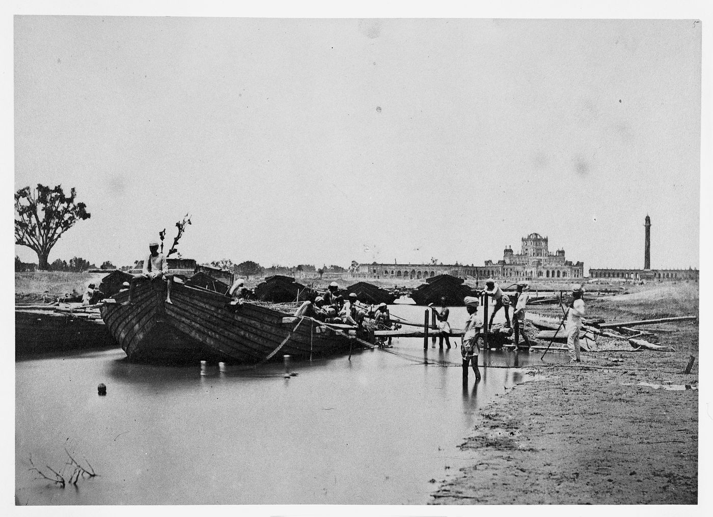 View of a bridge of boats across the Jumna River (now the Yamuna River) showing La Martinière College in the background, Lucknow, India