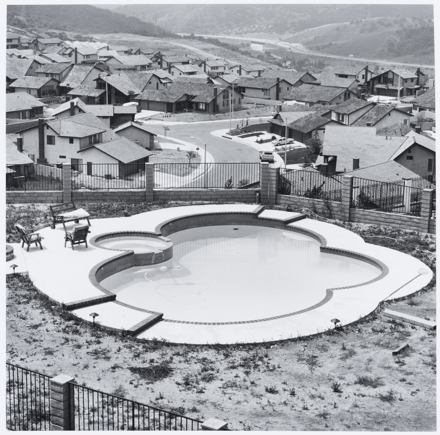 Fenced backyard with swimming pool, housing development below, Diamond Bar, California
