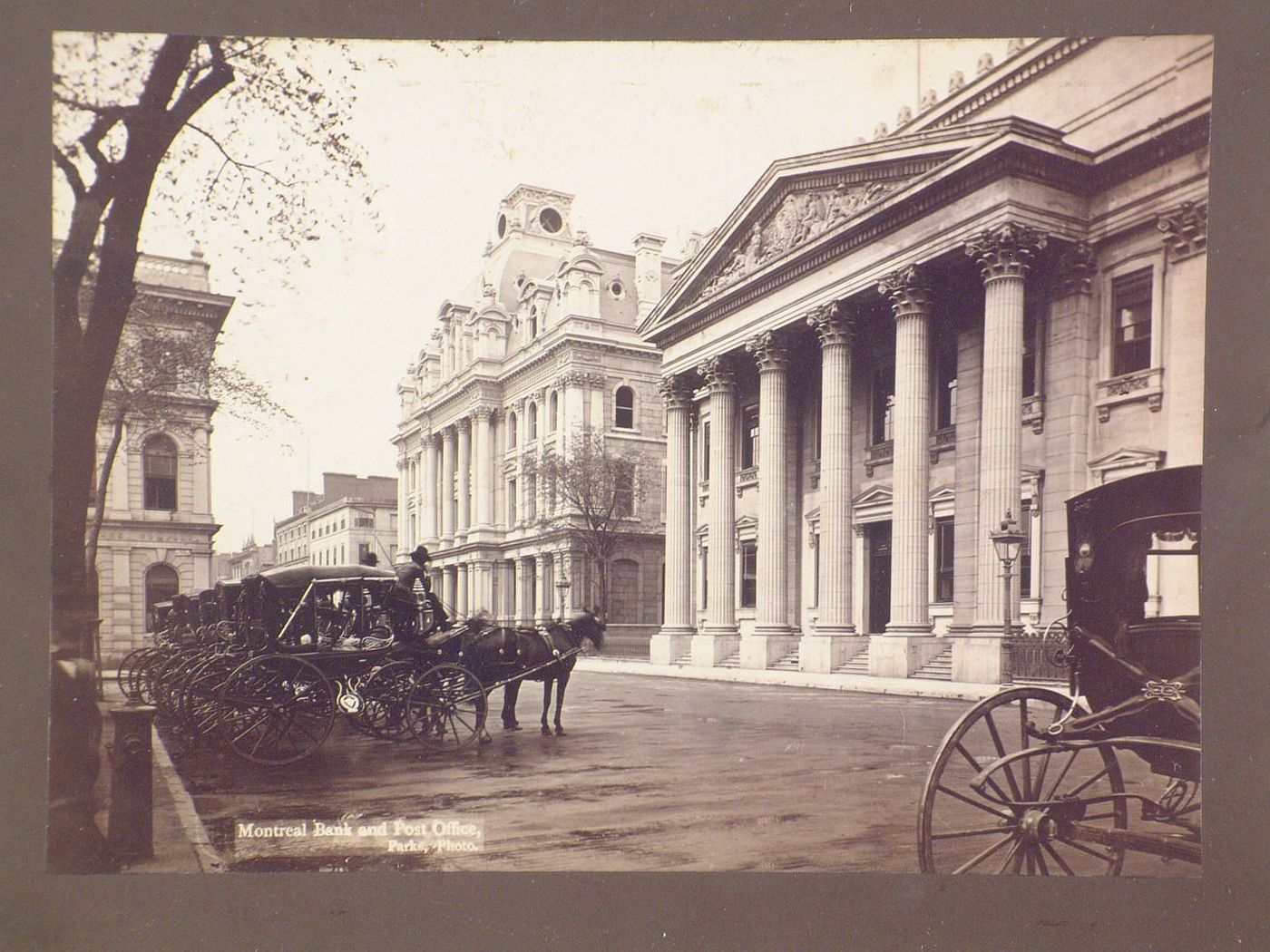 View of Montreal bank and post office with horses and carriages, Place d'Armes, Montreal, Quebec, Canada