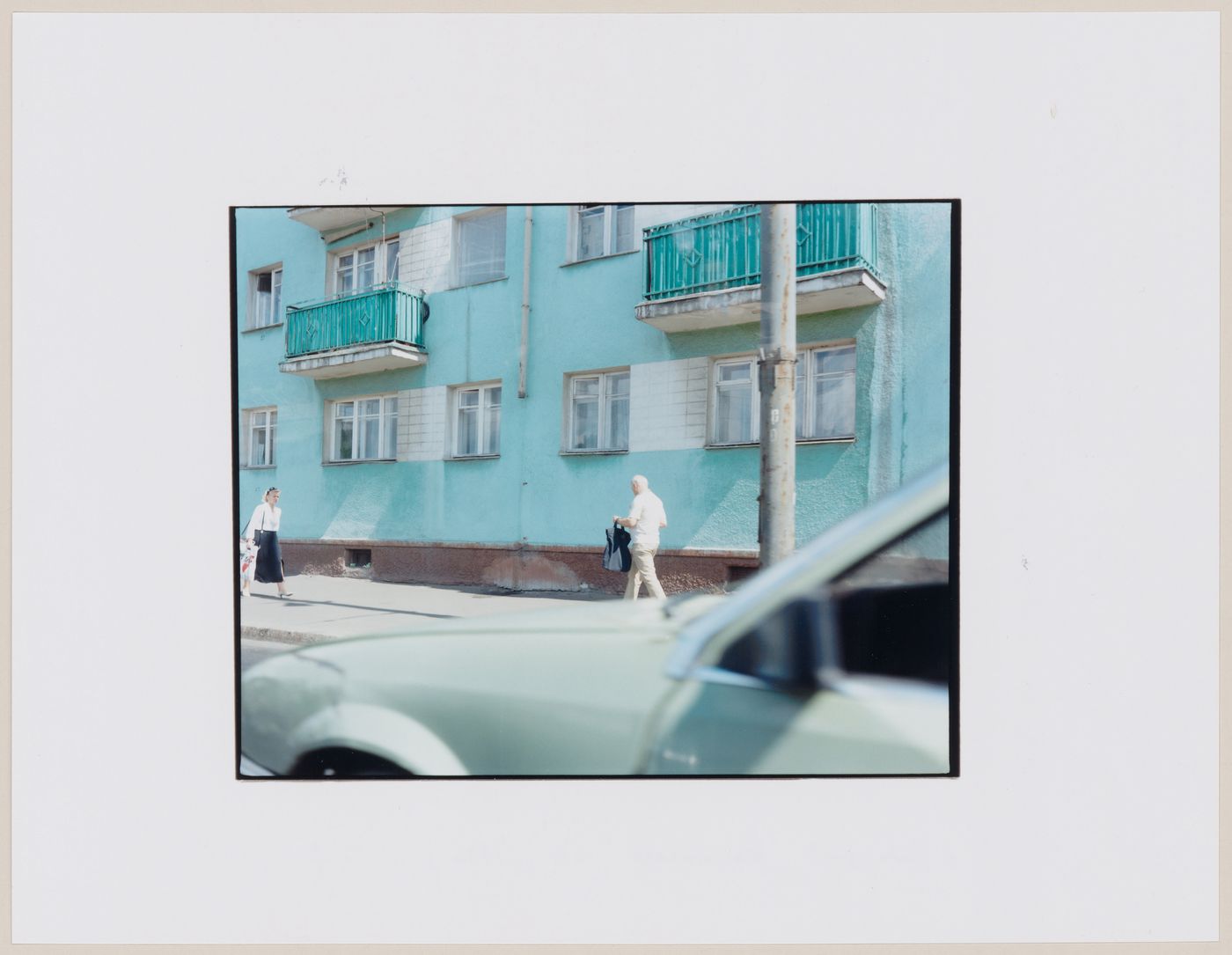 View of an apartment house and people showing an automobile in the foreground, Kaliningrad, Kaliningradskaia oblast', Russia (from the series "In between cities")