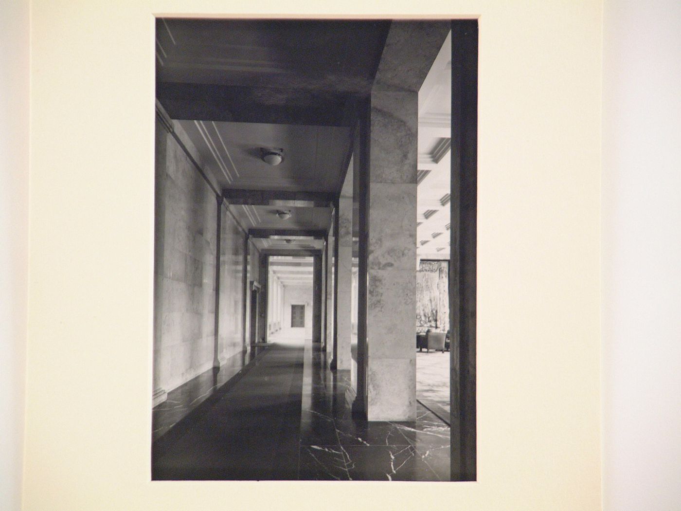 Interior view of hallway separated from large room with coffered ceiling by an open arcade, Munich, Germany