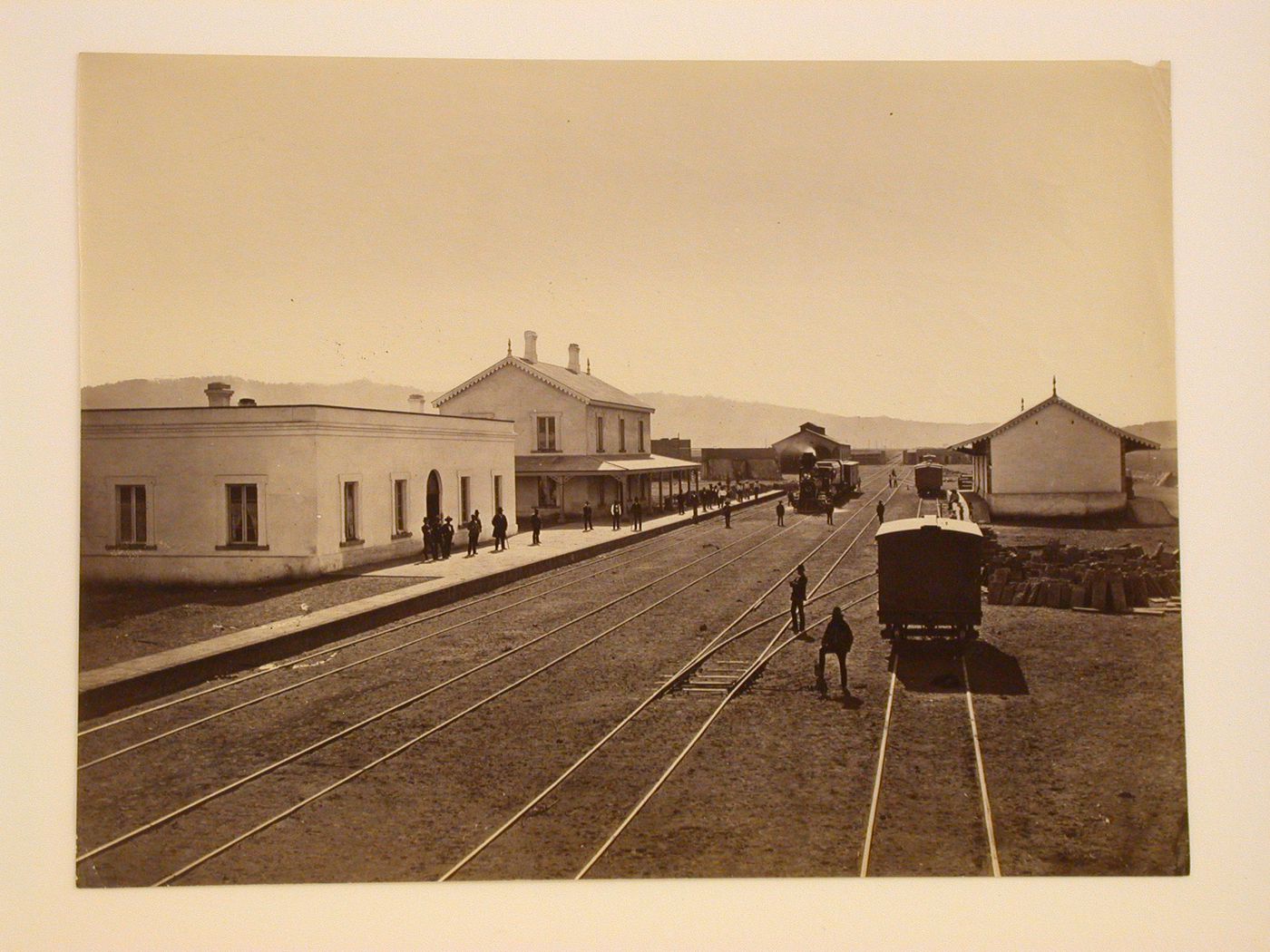 View of the Esperanza railway station showing men standing on the platform and throughout, Mexico