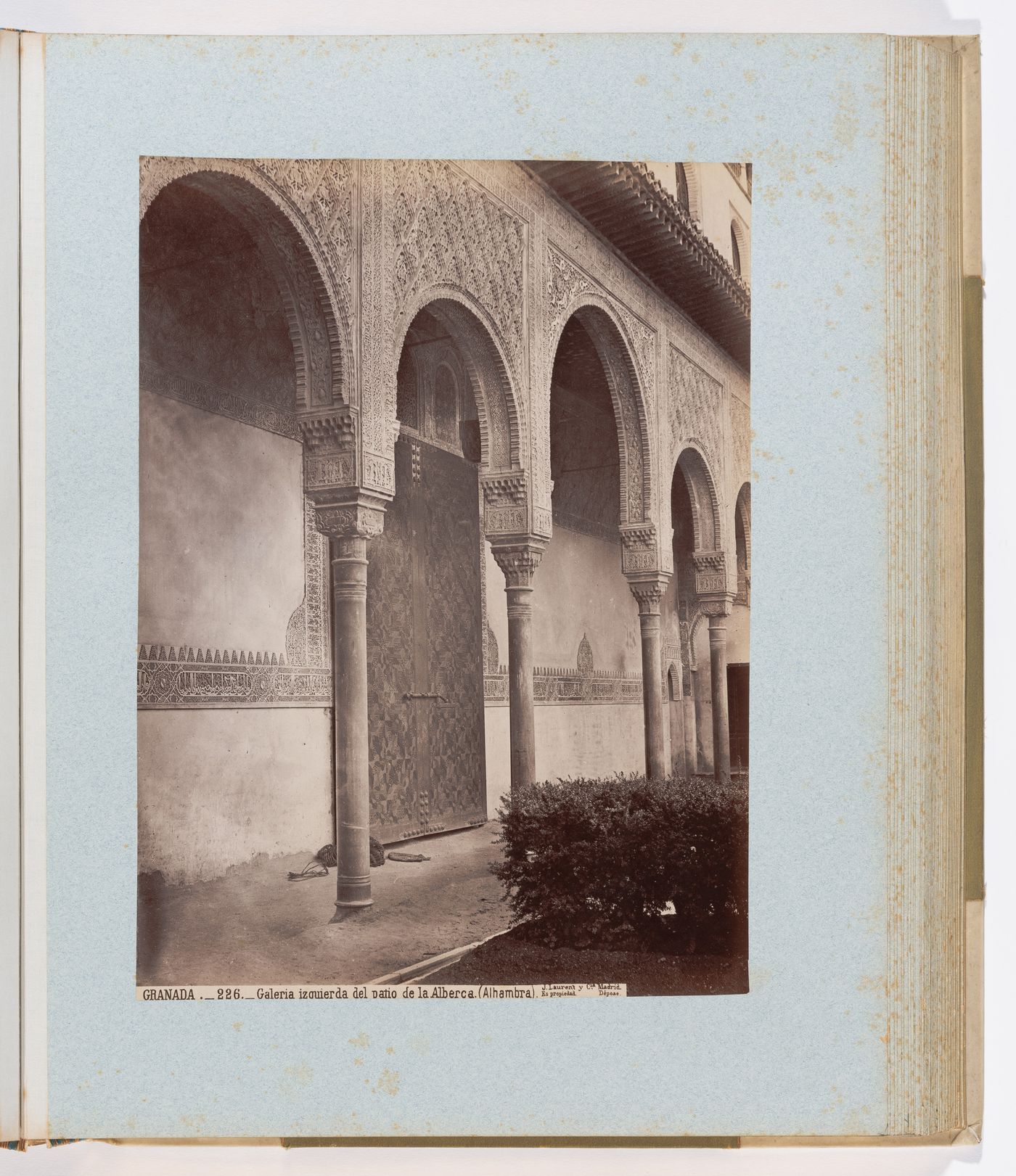 View of arches, door, and Arabic calligraphy facing south of the Court of the Myrtles, Alhambra, Granada, Spain
