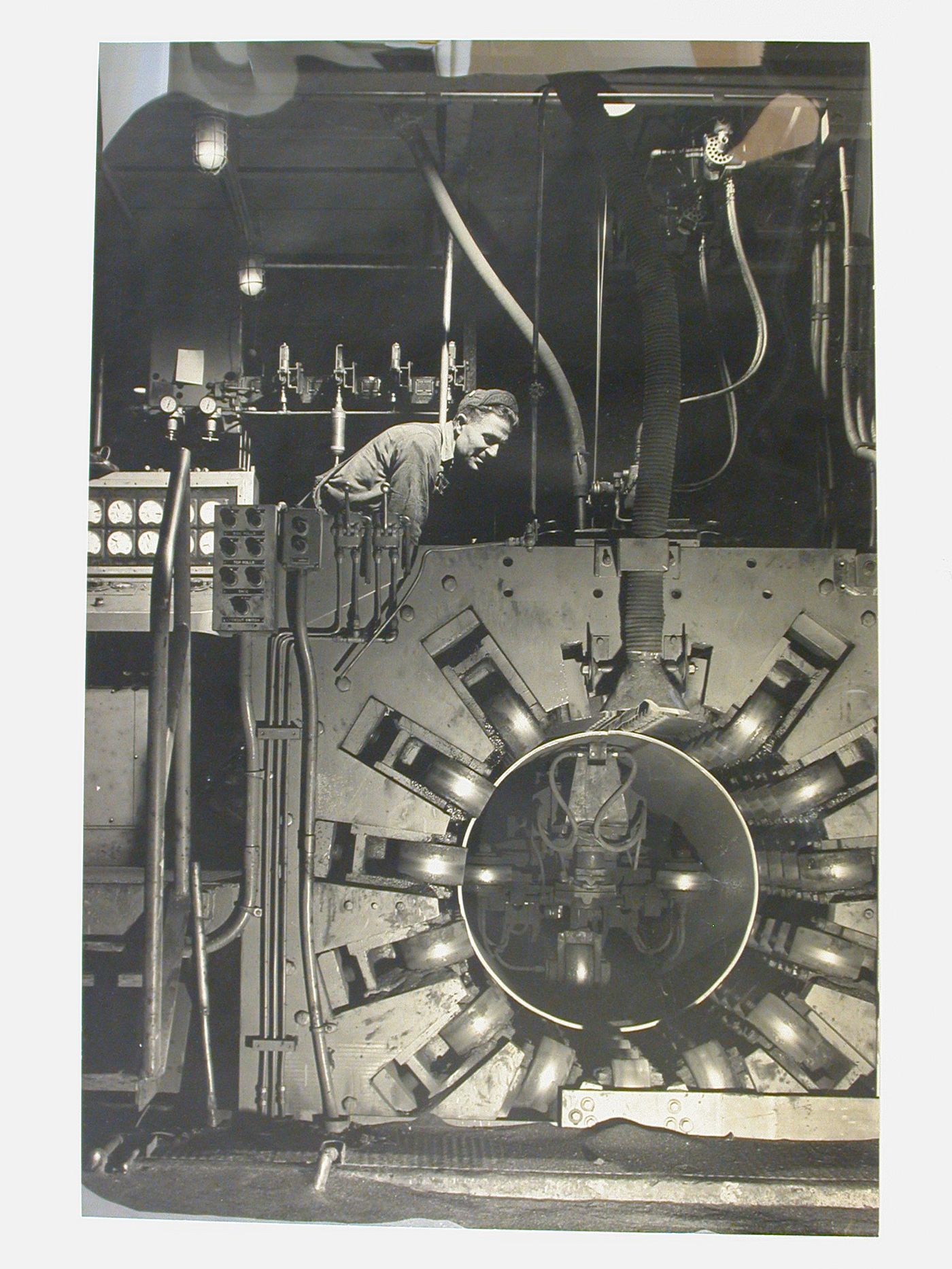 Worker leaning over large machine, San Francisco, California