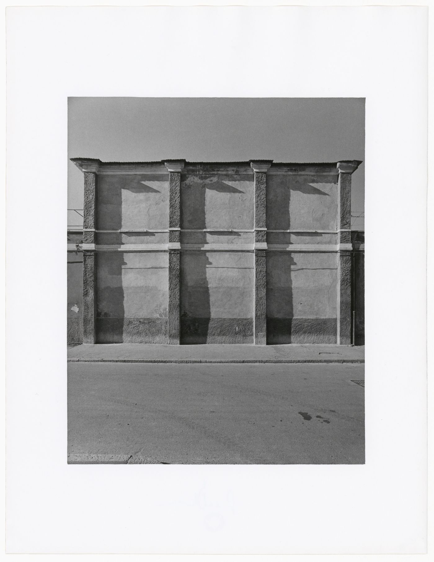 View of warehouse with brick wall in front, taken from across the street, via Raffaele Rubattino, Milan, Italy