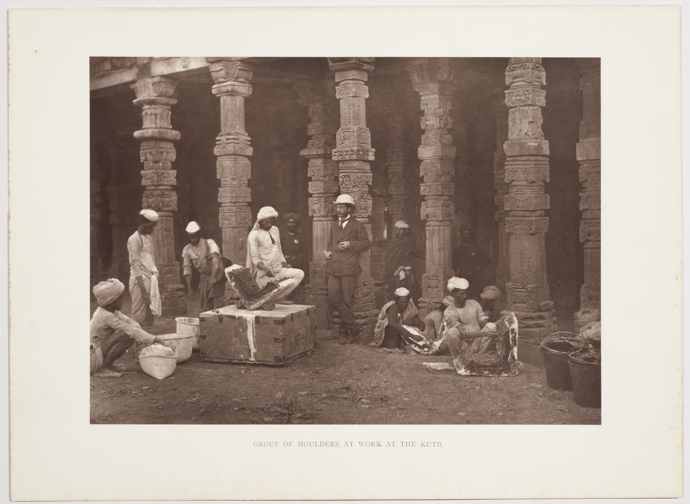 View of moulders working under supervision of Henry Hardy Cole, in the courtyard of the Quwwat al-Islam mosque, in the Qutb Minar complex, with colonnade in the background, Delhi, India