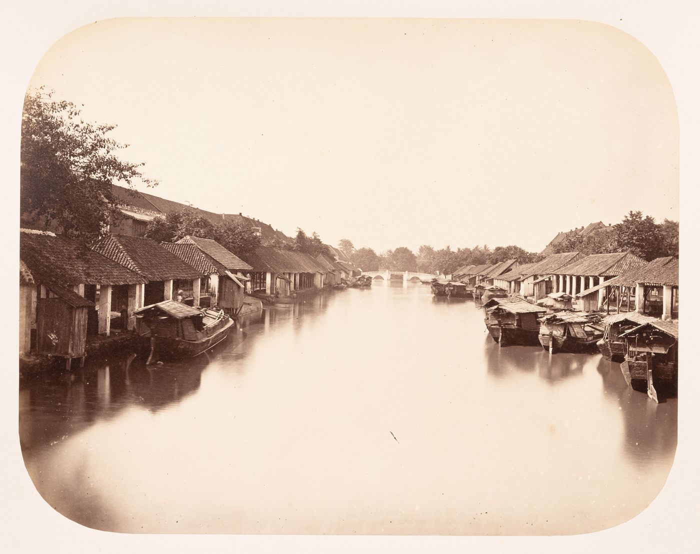 View of the Besar River showing godowns, a bridge and boats, Batavia (now Jakarta), Dutch East Indies (now Indonesia)