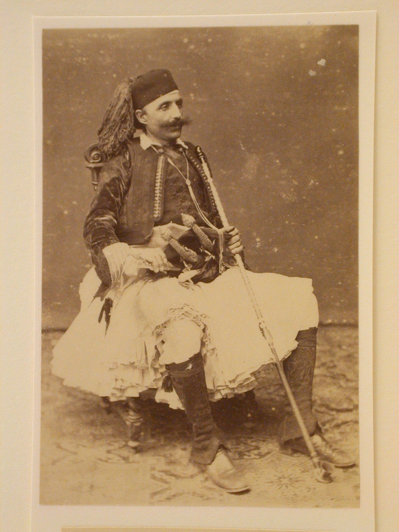 Seated man in Greek dress