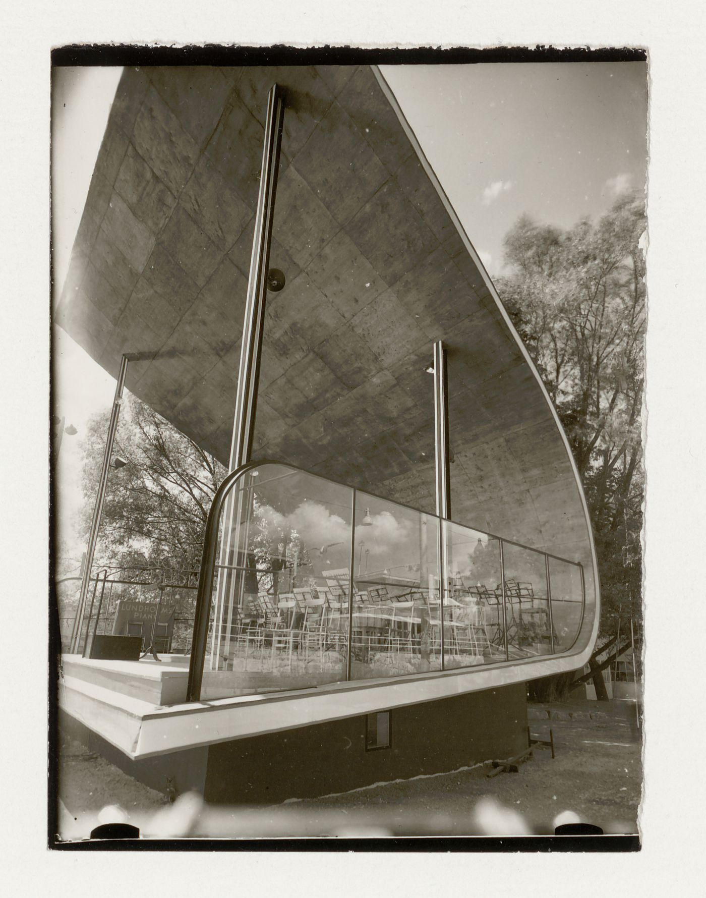 Exterior view of a bandstand at the Stockholm Exhibition of 1930 showing chairs and music stands, Stockholm