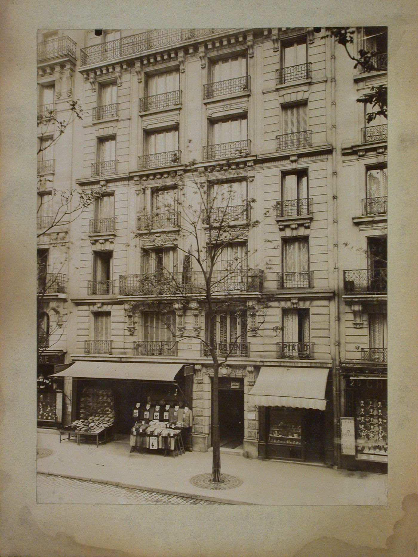 View of stores and partial view of apartment houses, Paris, France
