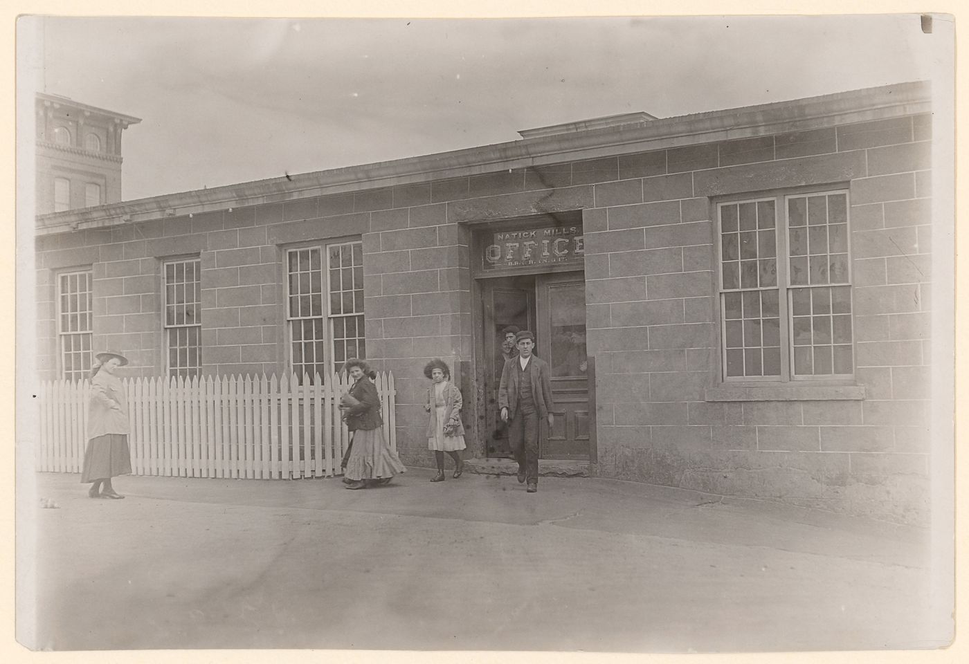 View of young girl and workers leaving Natick Mills at noon, Natick, Rhode Island, United States