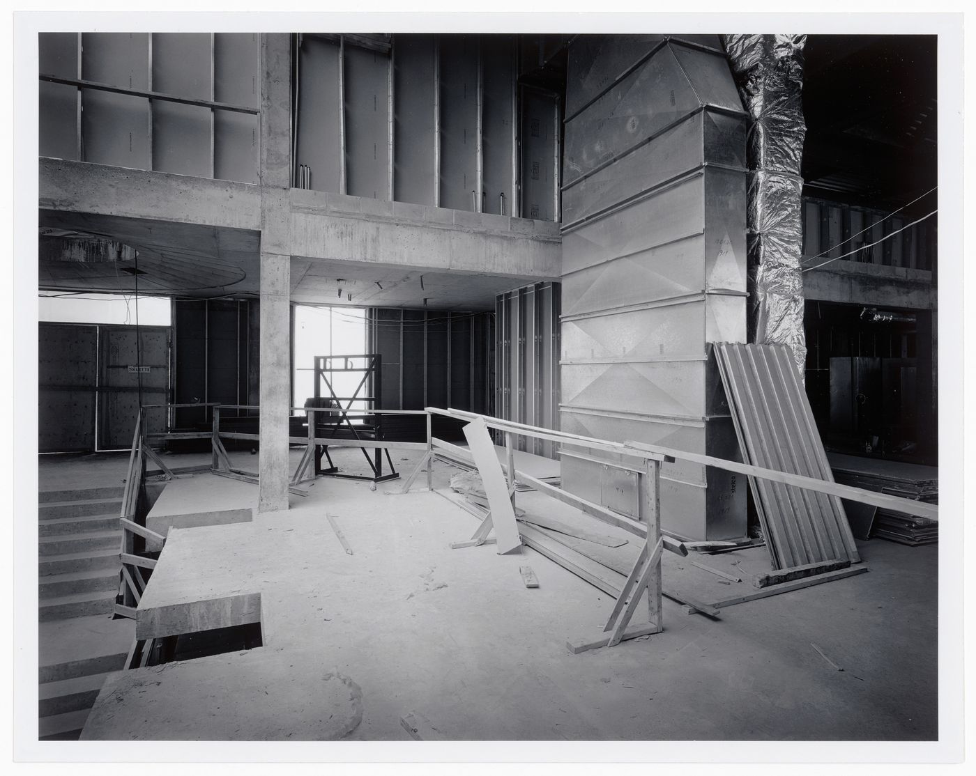 Interior view of the Entrance Court showing air ducts and building materials, Canadian Centre for Architecture under construction, Montréal, Québec