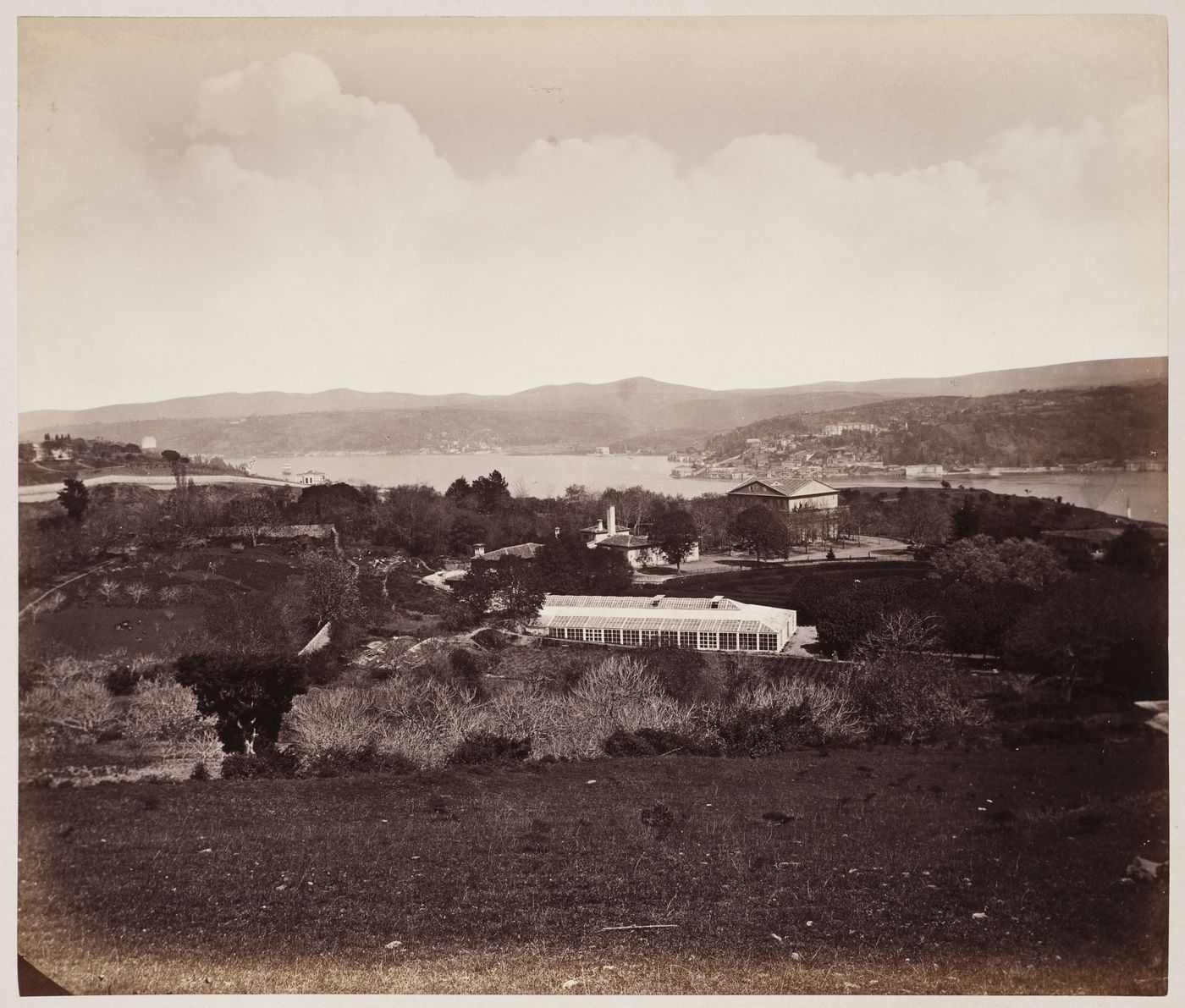 View across the Bosporus with houses and a greenhouse in the foreground and possibly showing the Küçüksu Palace (also known as the Göksu Palace) in the central background, Constantinople (now Istanbul), Ottoman Empire (now in Turkey)