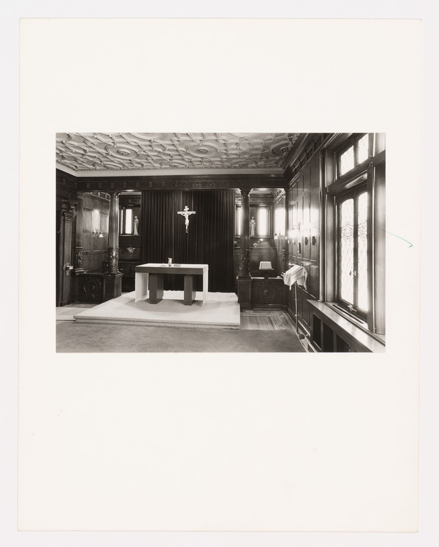 Interior view of the library (now demolished) in the east part of Shaughnessy House showing an altar and a crucifix, Montréal, Québec, Canada