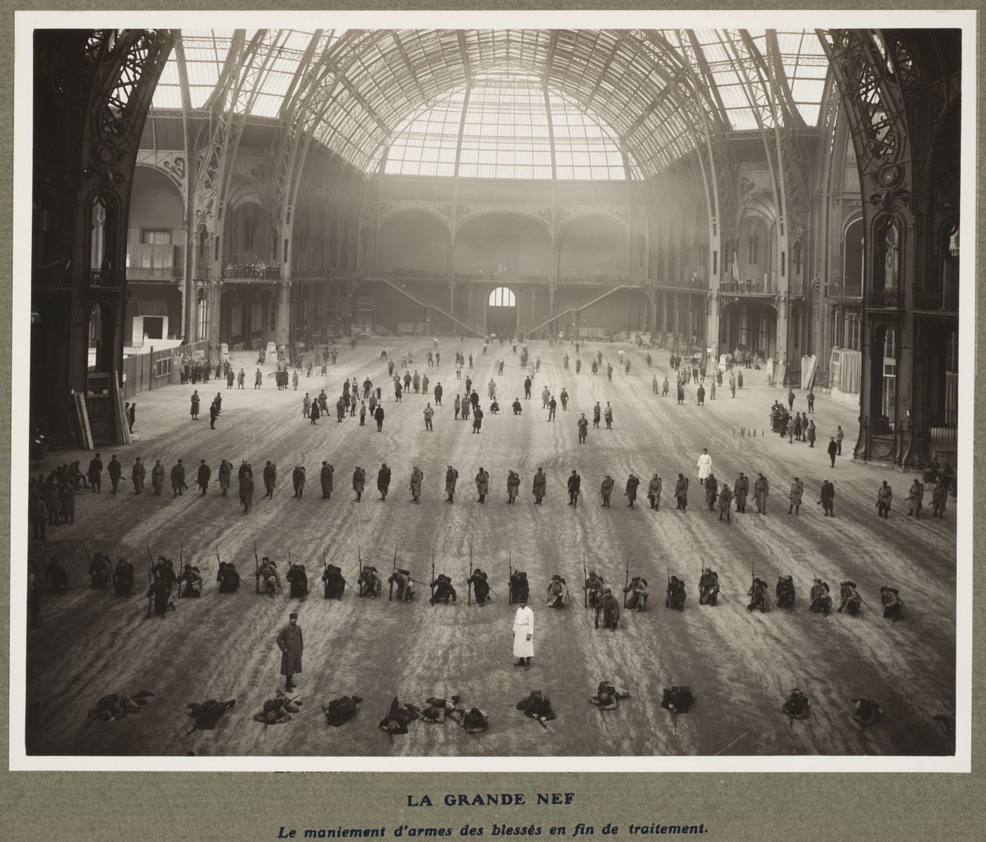 Interior view of soldiers, some armed, in the Grand Nave in the military hospital housed in the Grand Palais during World War I, Paris, France