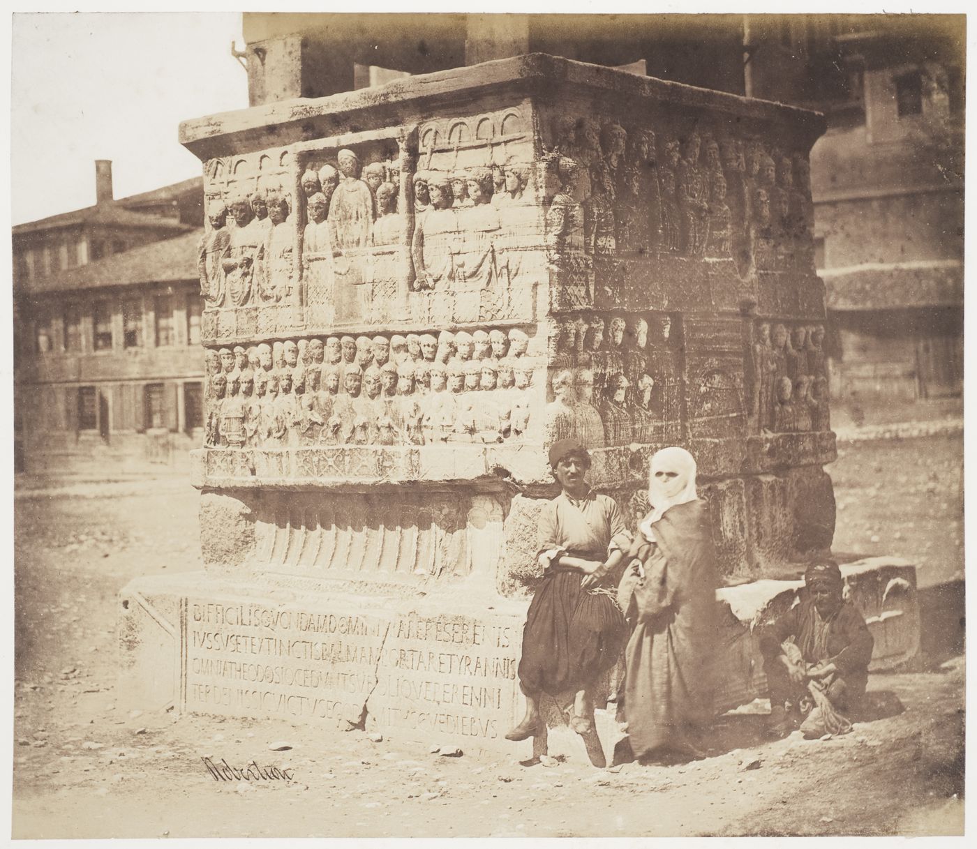 View of people at the base of the Obelisk of Emperor Theodosius I, Constantinople (now Istanbul), Ottoman Empire (now in Turkey)