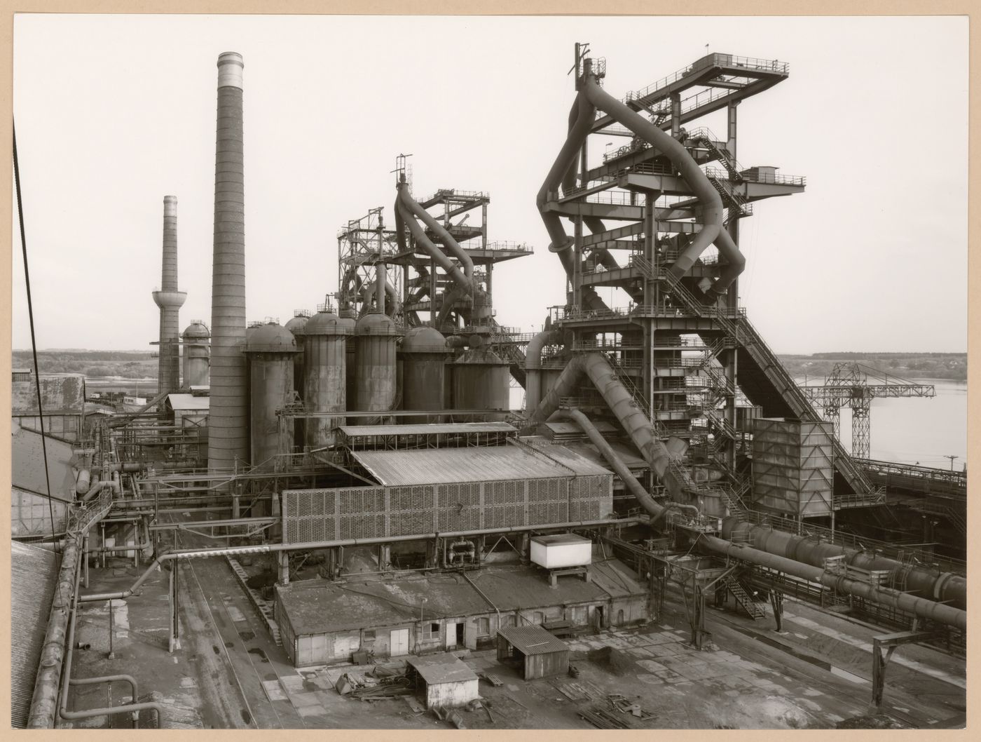 View of Metallhüttenwerk industrial plant showing blast furnace heads A, B, and C, Lübeck-Herrenwyk, Germany