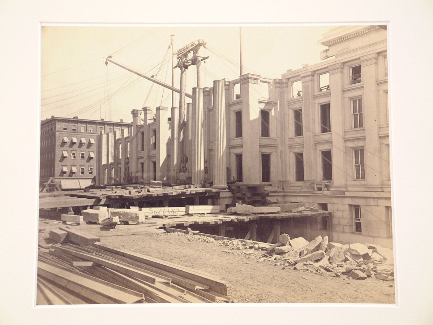 Treasury Building under contruction: Three-quarter view of façade and columns, scaffolding in front, Washington, District of Columbia